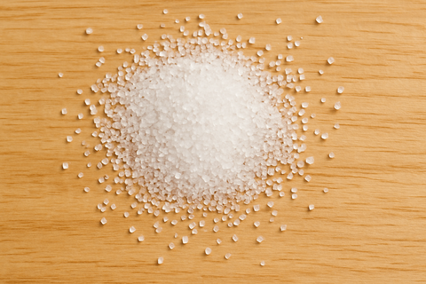 coarse white sugar on light wood background